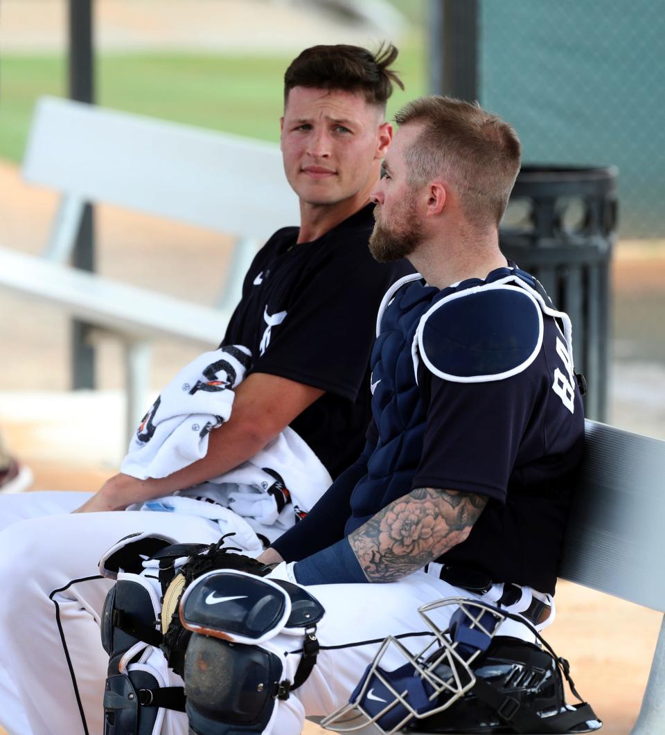Tigers pitcher Matt Manning, left, talks with catcher Tucker Barnhart after live batting practice during Detroit Tigers spring training on Wednesday, March 16, 2022, at TigerTown in Lakeland, Florida.