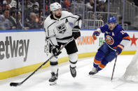 Los Angeles Kings defenseman Drew Doughty (8) looks to pass in front of New York Islanders right wing Cal Clutterbuck in the second period of an NHL hockey game Thursday, Jan. 27, 2022, in Elmont, N.Y. (AP Photo/Adam Hunger)