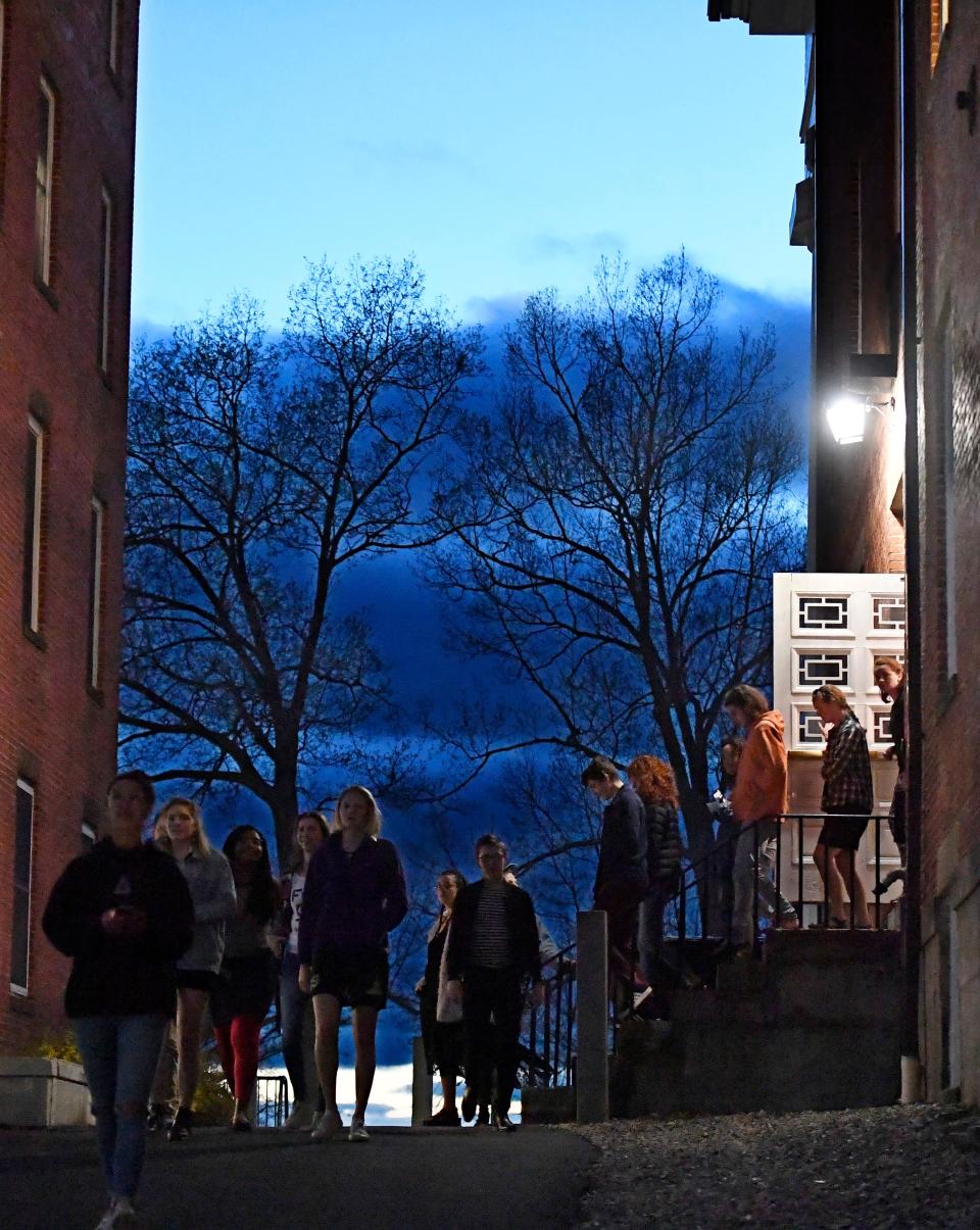 Students walk out of Johnson Chapel at Amherst College in Amherst, Mass., on April 24, 2019.