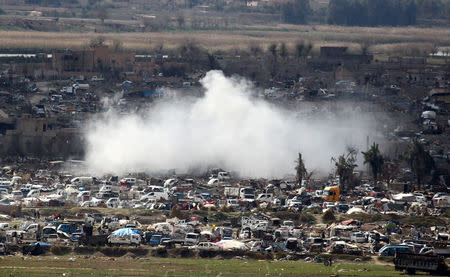 Smoke rises from the last besieged neighborhood in the village of Baghouz, Deir Al Zor province, Syria March 17, 2019. REUTERS/Stringer