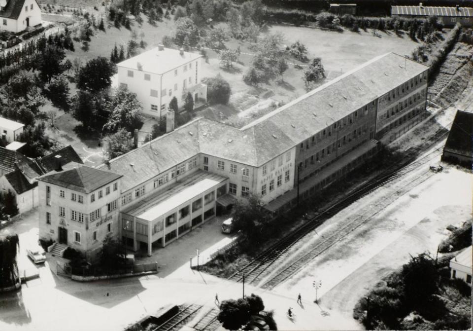 Adidas Founder Adolf Dassler house (large white building in the top of the frame) became part of the factory site and later the offices of the business HQ. It remained a part of the Adidas company until 2019. Courtesy of Adidas