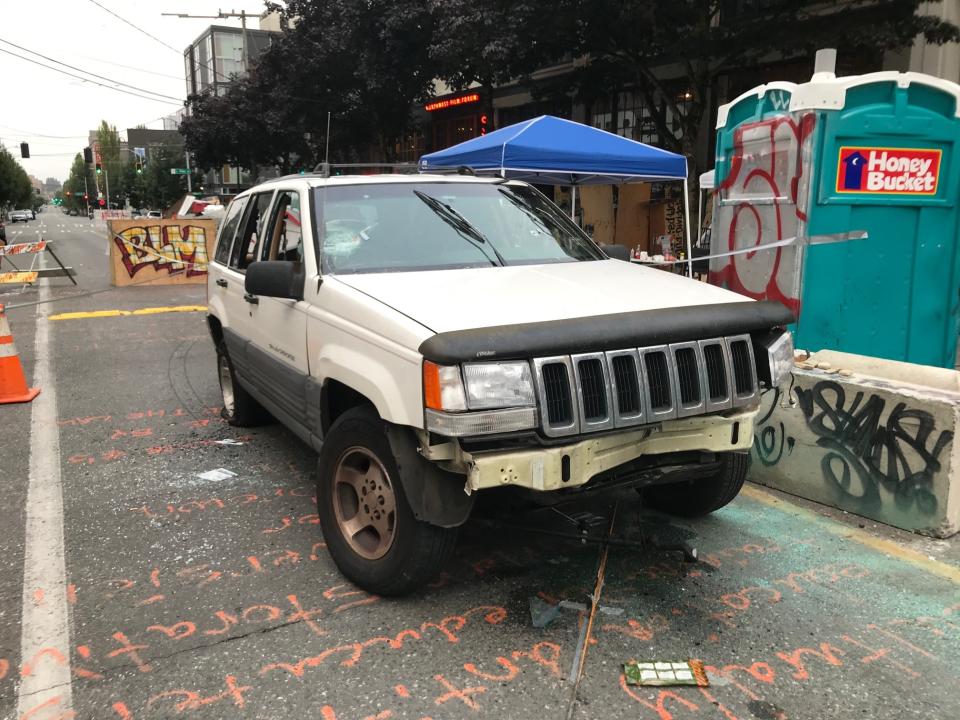 A car sits in the Capitol Hill Organized Protest zone following a shooting in Seattle early Monday, June 29, 2020. At least one man was killed and another was wounded early Monday morning when they were shot in the protest area known as CHOP, after driving the vehicle into the area. (AP Photo/Aron Ranen)