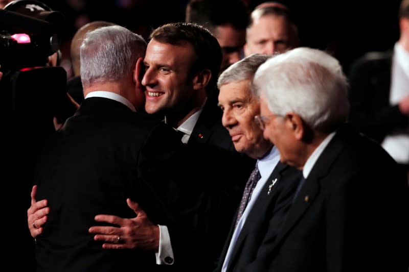 French President Emmanuel Macron is greeted by Israeli Prime Minister Benjamin Netanyahu during the World Holocaust Forum marking 75 years since the liberation of the Nazi extermination camp Auschwitz, at Yad Vashem Holocaust memorial centre in Jerusalem