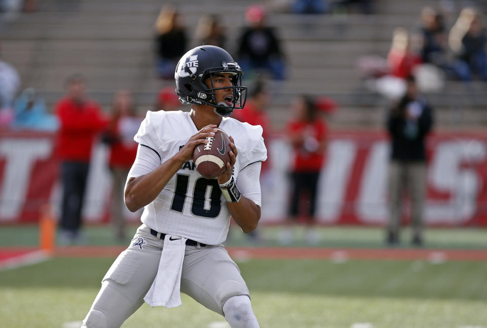 Utah State quarterback Jordan Love searches for a receiver during the first half of an NCAA college football game against New Mexico in Albuquerque, N.M., Saturday, Nov. 4, 2017. (AP Photo/Andres Leighton)