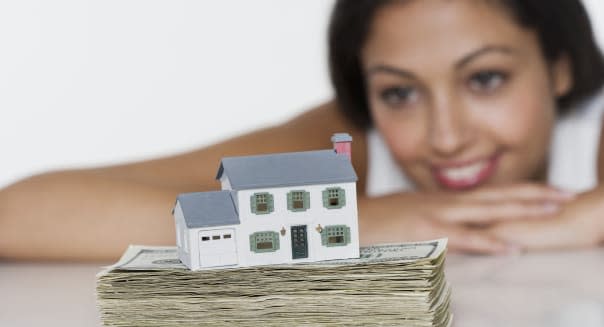 Woman looking at house savings