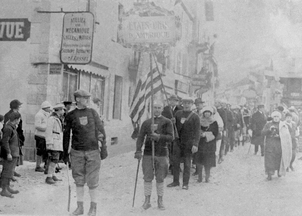 FILE - A man carries the American flag, as the United States is represented during opening ceremonies for the I Winter Olympics in Chamonix, France, on Jan. 25, 1924. The first so-called Modern Olympics were held in 1896 in Athens. The Winter Olympics were not organized until 28 years later with the first taking place in 1924 in Chamonix. (AP Photo, File)