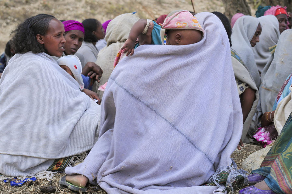 Ethiopian women gather at a community meeting in Mai Mekden, in the Tigray region of northern Ethiopia, on Tuesday, Feb. 27, 2024. Mothers, faces etched with worry, watch helplessly as their children weaken from malnutrition. The Ethiopian region of Tigray is peaceful but war’s effects linger, compounded by drought and a level of aid mismanagement that caused the U.N. and the U.S. to temporarily suspend deliveries last year. (AP Photo/Amir Aman Kiyaro)