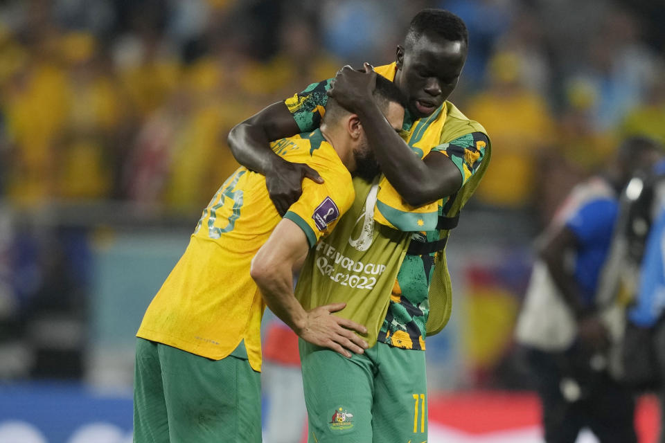 Australia's Aziz Behich, left, and Awer Mabil, right, react at the end of the World Cup round of 16 soccer match between Argentina and Australia at the Ahmad Bin Ali Stadium in Doha, Qatar, Saturday, Dec. 3, 2022. Argentina defeated Australia 2-1. (AP Photo/Frank Augstein)