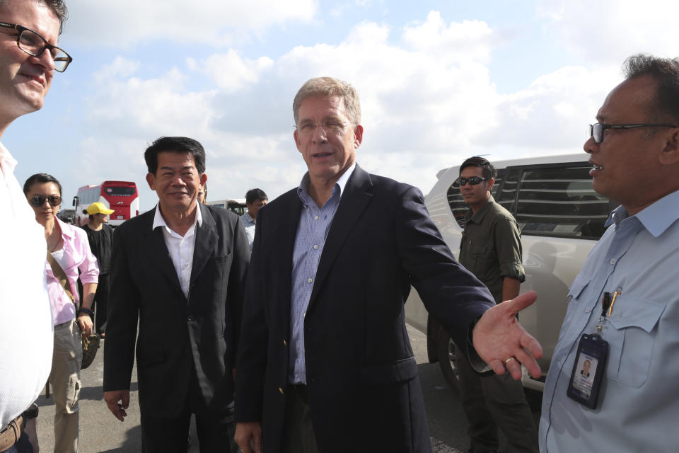 U.S. Ambassador to Cambodia W. Patrick Murphy, center, arrives at the sea port where the MS Westerdam, owned by Holland America Line, docked in Sihanoukville, Cambodia, Saturday, Feb. 15, 2020. After being stranded at sea for two weeks because five ports refused to allow their cruise ship to dock, the passengers of the MS Westerdam were anything but sure their ordeal was finally over. (AP Photo/Heng Sinith)