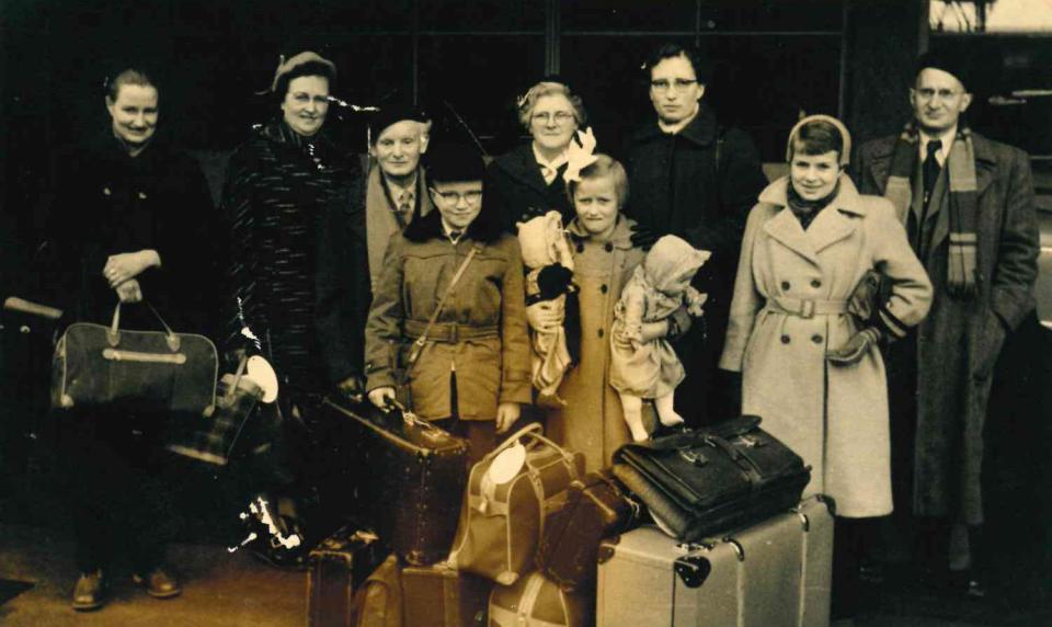 A family picture with Fredericka Rita Price's grandparents when they were leaving for the United States. Price is standing in the front right holding a bag.