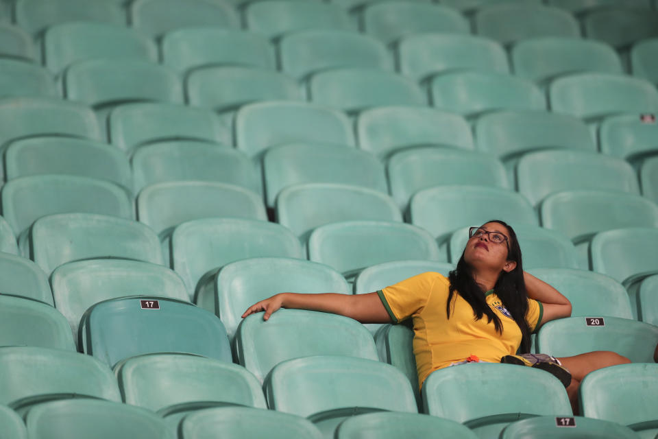 A Brazilian fan rests after a Copa America Group A soccer match against Venezuela at the Arena Fonte Nova in Salvador, Brazil, Tuesday, June 18, 2019. The match end 0-0. (AP Photo/Natacha Pisarenko)