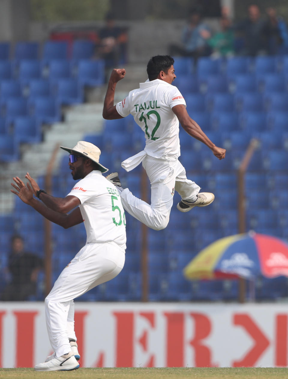 Bangladesh's Taijul Islam right celebrates wicket of India' Virat Kohli during the first Test cricket match day one between Bangladesh and India in Chattogram Bangladesh, Wednesday, Dec. 14, 2022. (AP Photo/Surjeet Yadav)