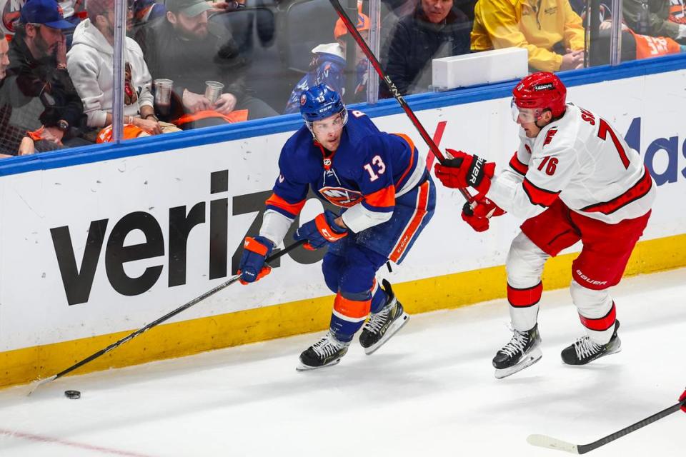 Apr 27, 2024; Elmont, New York, USA; New York Islanders center <a class="link " href="https://sports.yahoo.com/nhl/players/6758/" data-i13n="sec:content-canvas;subsec:anchor_text;elm:context_link" data-ylk="slk:Mathew Barzal;sec:content-canvas;subsec:anchor_text;elm:context_link;itc:0">Mathew Barzal</a> (13) and Carolina Hurricanes defenseman <a class="link " href="https://sports.yahoo.com/nhl/players/5708/" data-i13n="sec:content-canvas;subsec:anchor_text;elm:context_link" data-ylk="slk:Brady Skjei;sec:content-canvas;subsec:anchor_text;elm:context_link;itc:0">Brady Skjei</a> (76) battle for control of the puck in the first period in game four of the first round of the 2024 Stanley Cup Playoffs at UBS Arena. Mandatory Credit: Wendell Cruz-USA TODAY Sports Wendell Cruz/Wendell Cruz-USA TODAY Sports