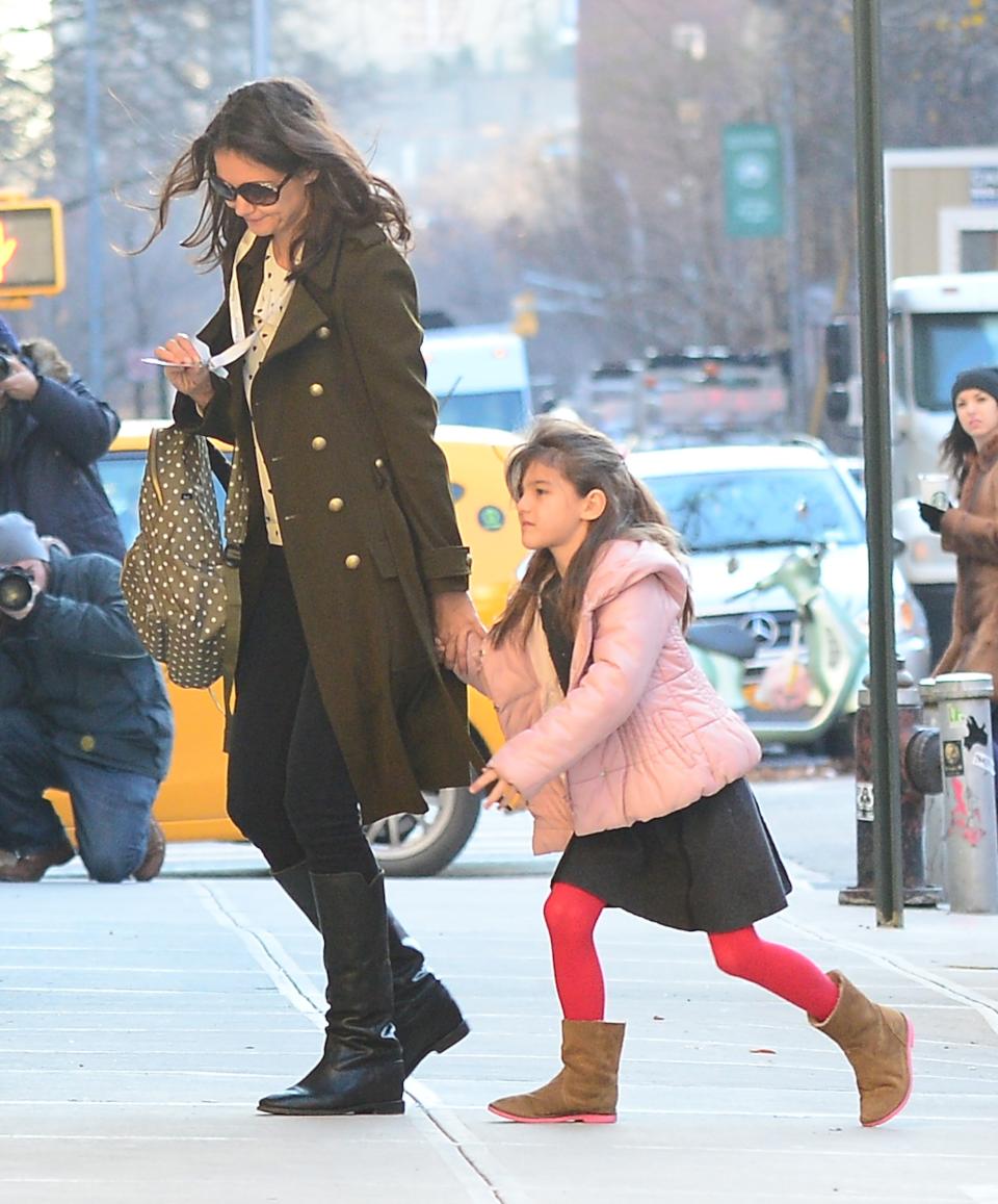 Katie Holmes  and  Suri Cruise are seen walking  Chelsea on December 11, 2013 in New York City.  (Photo by Raymond Hall/FilmMagic)