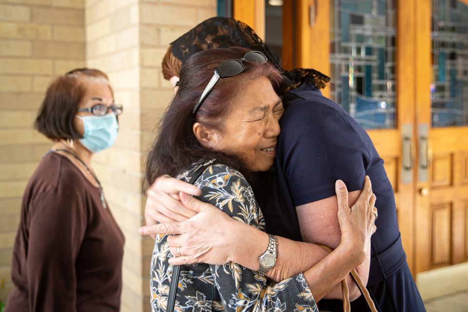 Rose Conner, a substitute teacher in Uvalde, hugs a woman outside of Sacred Heart Catholic Church in Uvalde, Texas, before a 10 a.m. mass on May 25, 2022. Conner was subbing at the high school when a gunman entered Robb Elementary School and killed at least 19 people. She said she the school was in lockdown until around 5:30 p.m.