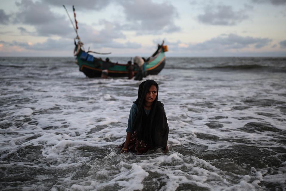 A Rohingya Muslim woman gets off a boat after crossing over from Myanmar into the Bangladesh side of the border, in Shah Porir Dwip near Cox's Bazar, Bangladesh on Sept. 13, 2017. Rohingya Muslims pay local fishers 36 U.S. dollars in order to cross to Shah Porir Dwip peninsula.