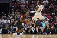 Milwaukee Bucks guard Javonte Smart (6) jumps in front of Miami Heat guard Kyle Lowry (7) during the first half of an NBA basketball game, Wednesday, Dec. 8, 2021, in Miami. (AP Photo/Marta Lavandier)