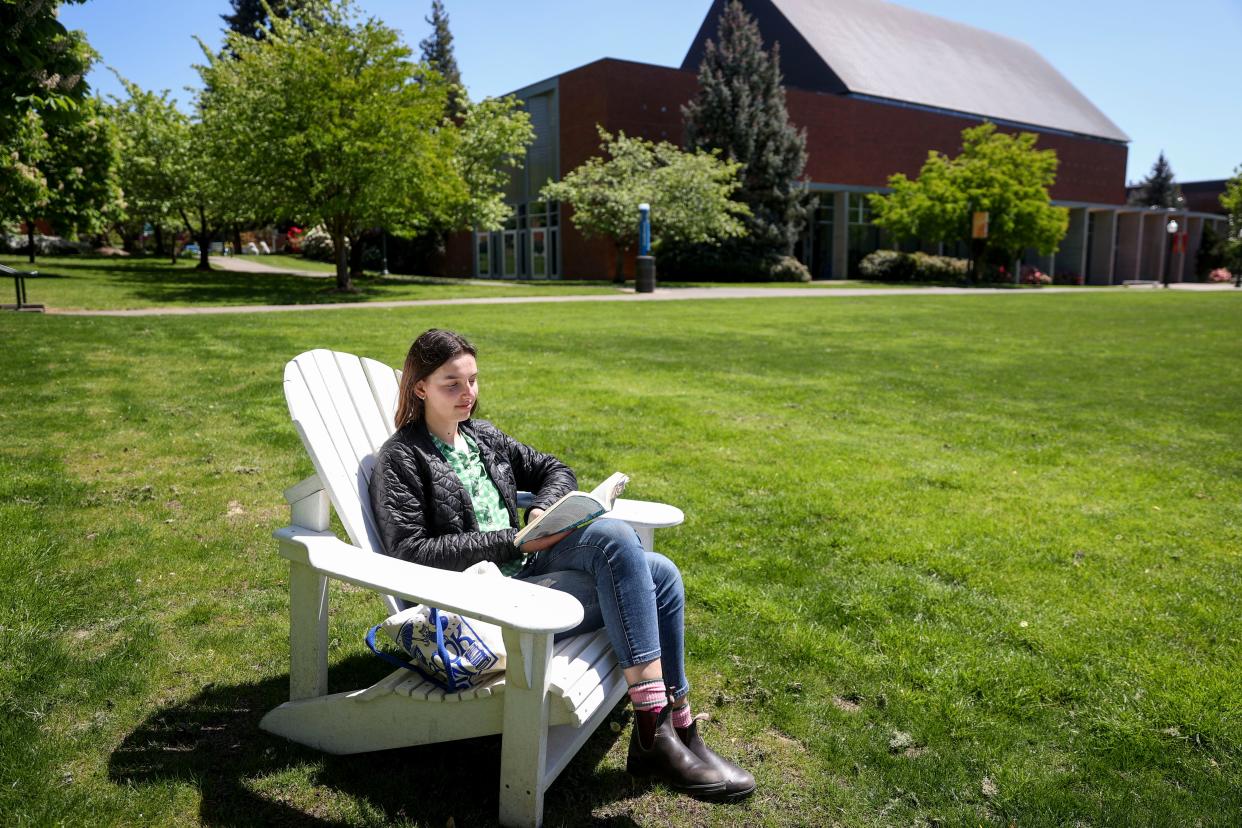 Maddy Maes reads a book and enjoys the sunshine during the final days of her freshman year at Willamette University on Wednesday, May 8, 2024 in Salem, Ore.