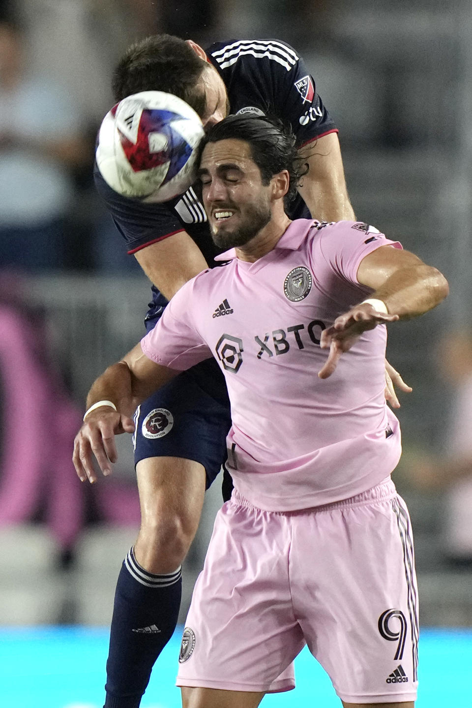 Inter Miami forward Leonardo Campana (9) heads the ball in front of New England Revolution defender Dave Romney during the first half of an MLS soccer match Saturday, May 13, 2023, in Fort Lauderdale, Fla. (AP Photo/Lynne Sladky)