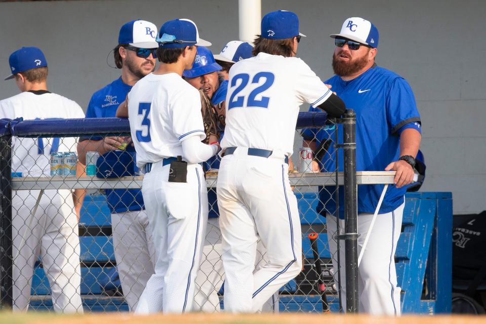 Barron Collier's head coach Charlie Maurer talks with Barron Collier's Carter White (22) before the FHSAA baseball Class 5A-Region 4 quarterfinal between Archbishop McCarthy and Barron Collier, Tuesday, May 10, 2022, at Barron Collier High School in Naples, Fla.Barron Collier defeated Archbishop McCarthy 3-2.