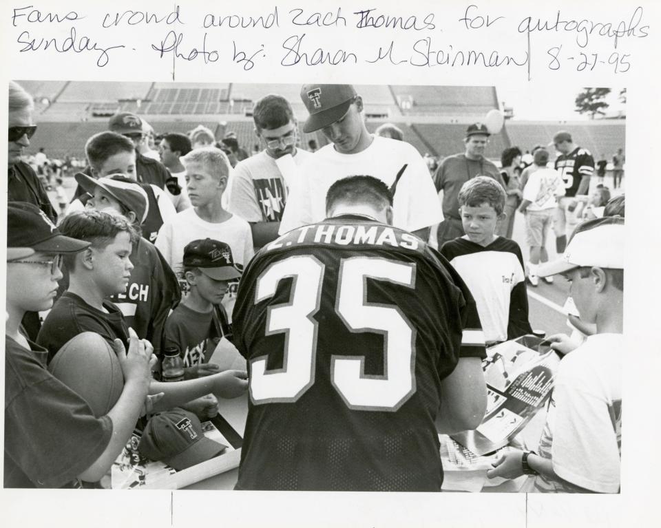Texas Tech fans crowd around Red Raiders linebacker Zach Thomas (35) during a preseason autograph session in August 1995.