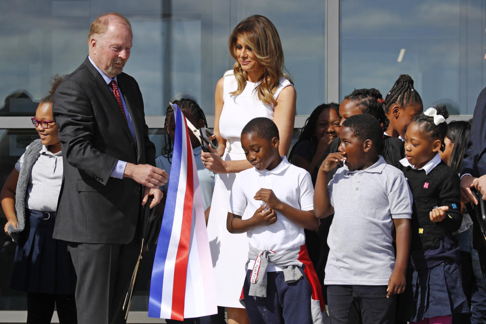 First lady Melania Trump, center, and Department of Interior assistant secretary Rob Wallace, left, participate in a ribbon-cutting ceremony with students from Amidon-Bowen Elementary School in Washington to re-open the Washington Monument, Thursday, Sept. 19, 2019, in Washington. The monument has been closed to the public for renovations since August 2016. (AP Photo/Patrick Semansky)