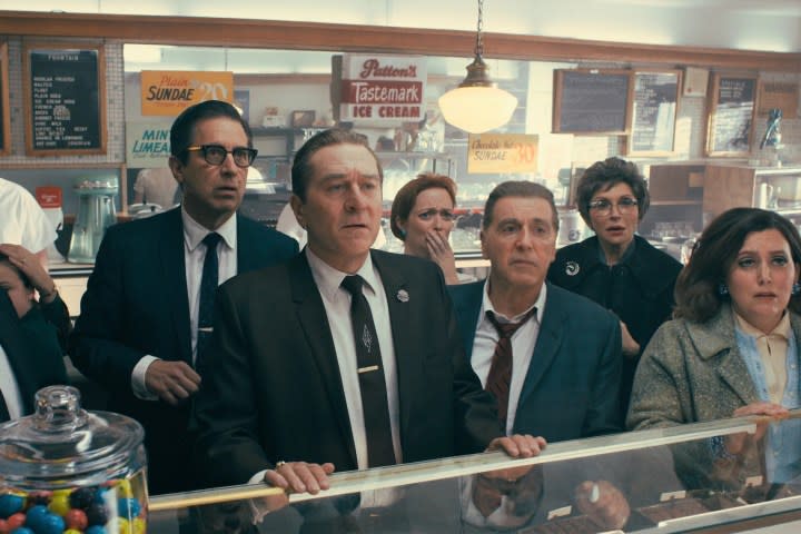 Robert De Niro and Al Pacino stand in a deli in The Irishman.