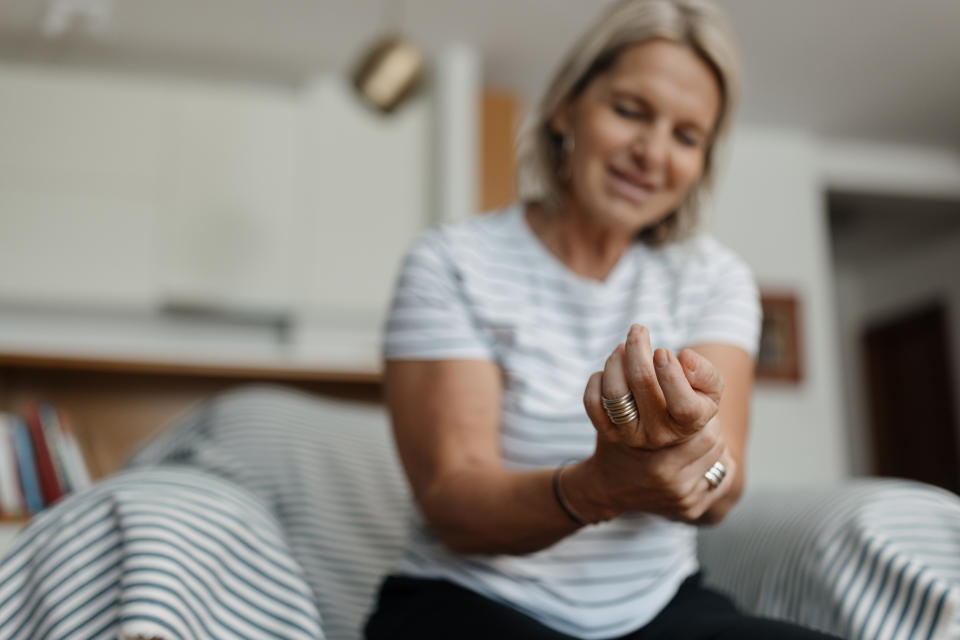 One mid adult woman having a joint pain due to osteoporosis