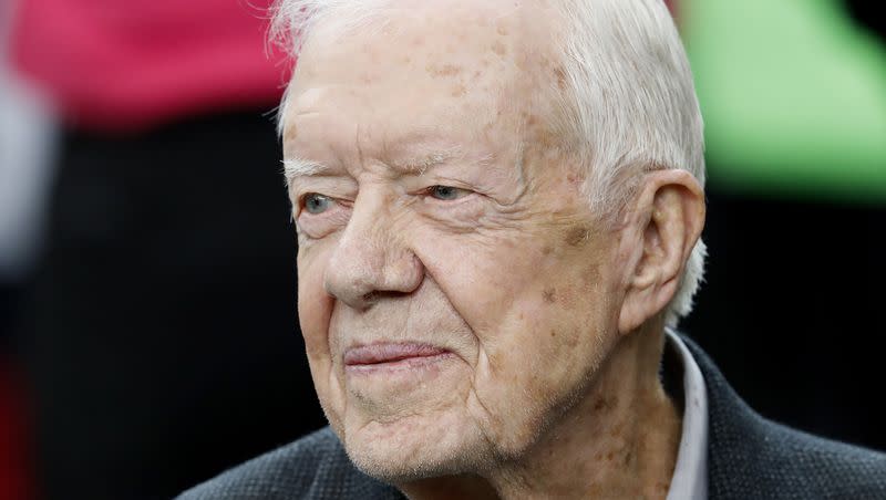 Former President Jimmy Carter sits on the Atlanta Falcons bench before an NFL football game between the Atlanta Falcons and the San Diego Chargers on Oct. 23, 2016, in Atlanta. Carter will turn 99 on Sunday.