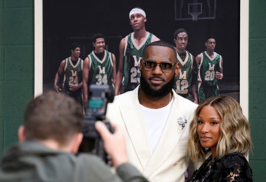 NBA basketball player LeBron James and his wife Savannah pose for a photo at the premiere of the Peacock film “Shooting Stars,” Wednesday, May 31, 2023, at the Regency Village Theatre in Los Angeles. The film chronicles the high school basketball years of James and his childhood friends at St. Vincent-St. Mary High School in Akron, Ohio. (AP Photo/Chris Pizzello)