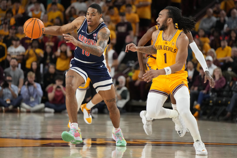 Arizona forward Keshad Johnson drives on Arizona State guard Frankie Collins (1) during the first half of an NCAA college basketball game, Wednesday, Feb. 28, 2024, in Tempe, Ariz. (AP Photo/Rick Scuteri)