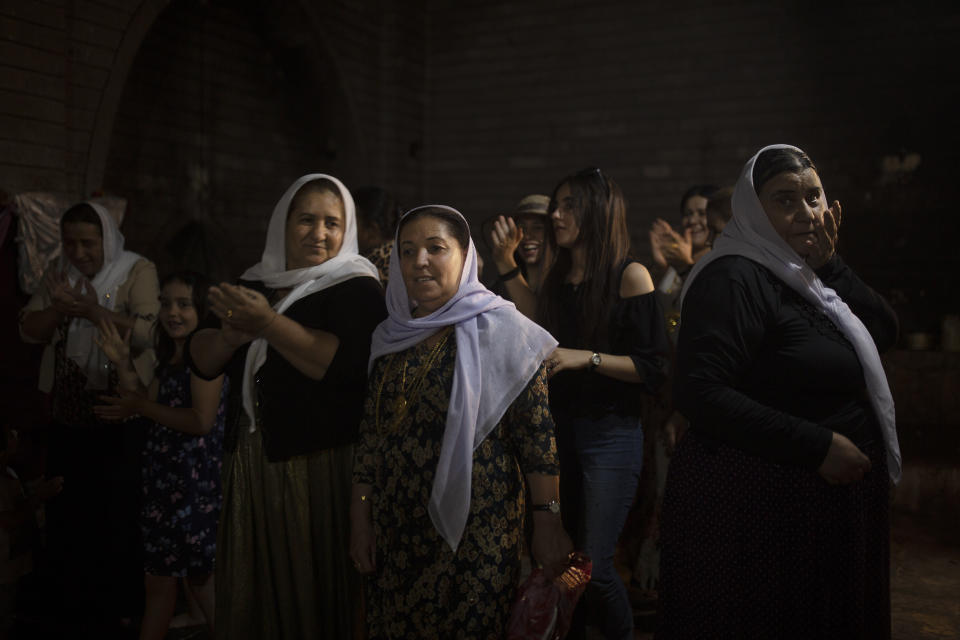 In this Sept. 12, 2019 photo, Yazidi women visit Lalish, the holiest Yazidi shrine, in Iraq's Dohuk province, in northern Iraq. During a week-long assault by Islamic State militants in 2014, they killed hundreds of Yazidis and abducted 6,417, more than half of them women and girls. (AP Photo/Maya Alleruzzo)