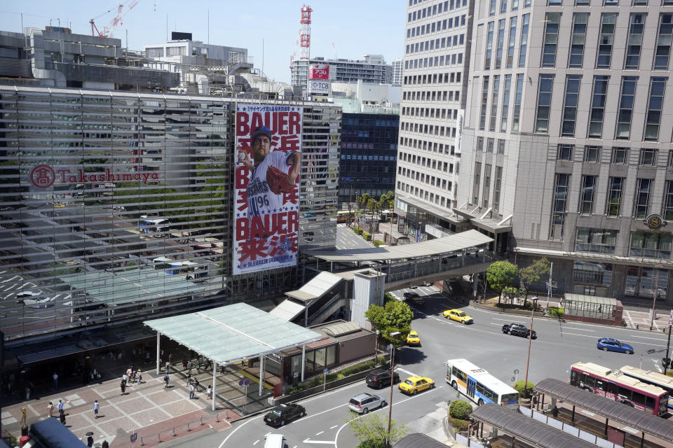 A giant banner of Trevor Bauer, who pitches for the Yokohama DeNA BayStars, is placed on a department store facade on Wednesday, May 3, 2023, in Yokohama near Tokyo. Bauer is pitching his first official game for the BayStars on Wednesday and, to promote the start, the local department store unveiled a seven-story poster of the former Cy Young winner on the building's facade. (AP Photo/Eugene Hoshiko)