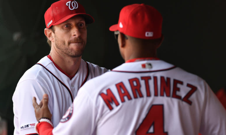 Max Scherzer talking with Dave Martinez in the dugout.