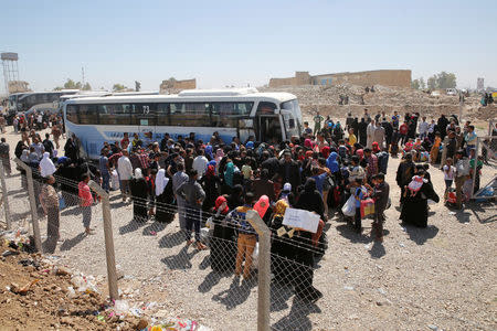 Displaced Iraqis who had fled their homes are seen as they wait for a transfer to eastern Mosul, after their arrival at Hammam al-Alil camp checkpoint south of Mosul, Iraq April 25, 2017. REUTERS/Muhammad Hamed