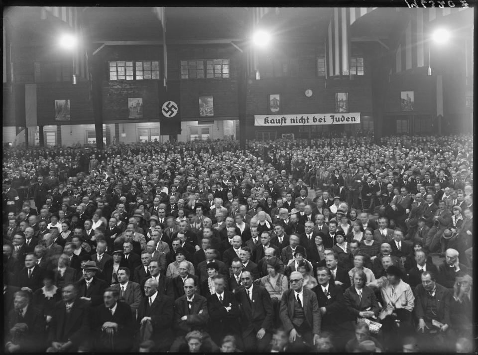 Party meeting or rally. Sign in the back reads: "Kauft nicht bei Juden"- Don't buy from Jews.<span class="copyright">Heinrich Hoffmann—courtesy of National Archives and Records Administration</span>