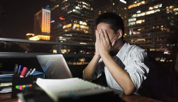 Chinese businessman working at desk at night