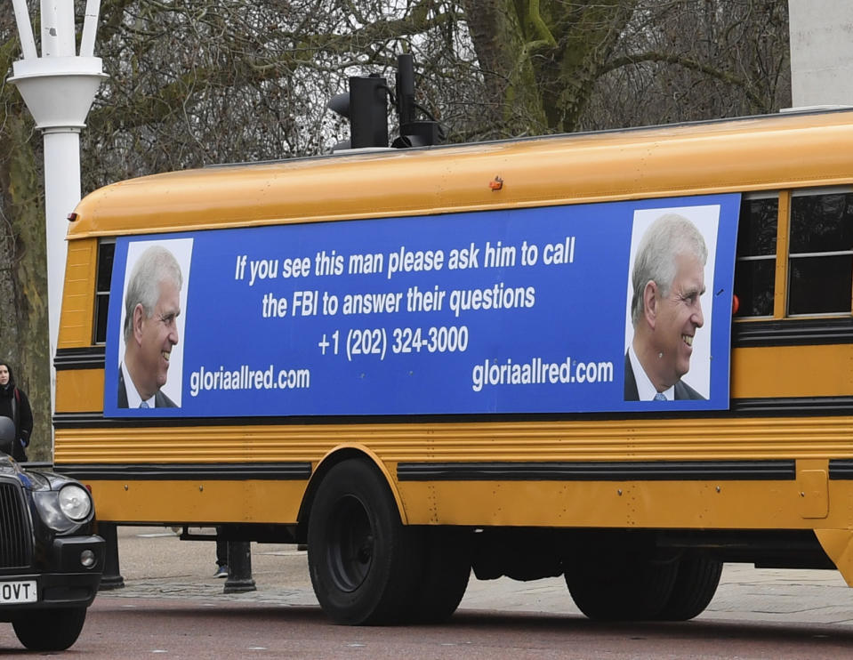 A yellow school bus with a message for the Britain's Prince Andrew, from US lawyer Gloria Allred, drives along The Mall towards Buckingham Palace in London Friday Feb. 21, 2020. Allred, who represents some of the accusers of Jeffrey Epstein, has been critical of the Prince Andrew for not speaking with the FBI about his former friend Epstein. Epstein died in a New York jail in August 2019 while he was awaiting trial on sex trafficking charges. U.S. authorities ruled the death a suicide. (Stefan Rousseau/PA via AP)
