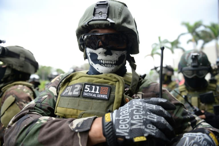 Members of the police Special Action Force (SAF) stand in front of the Philippine convention center, after a drill simulating a Paris-like attack, at the venue of Asia-Pacific Economic Cooperation (APEC) summit in Manila on November 14, 2015