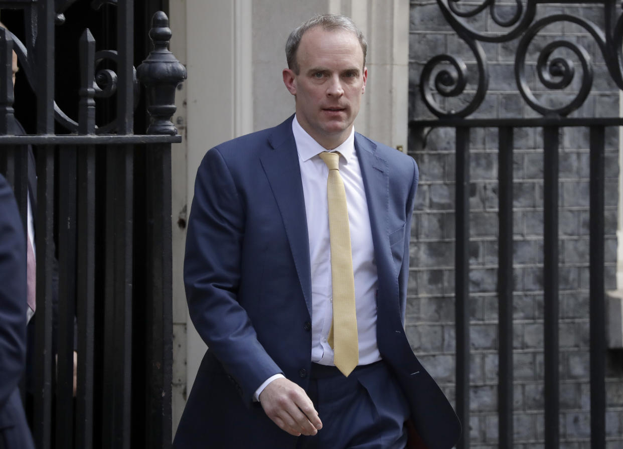 Britain's Secretary of State for Foreign Affairs, Dominic Raab, left, leaves 10 Downing Street after a meeting as British Prime Minister Boris Johnson was moved to intensive care after his coronavirus symptoms worsened in London, Tuesday, April 7, 2020. Johnson was admitted to St Thomas' hospital in central London on Sunday after his coronavirus symptoms persisted for 10 days. Having been in hospital for tests and observation, his doctors advised that he be admitted to intensive care on Monday evening. The new coronavirus causes mild or moderate symptoms for most people, but for some, especially older adults and people with existing health problems, it can cause more severe illness or death.(AP Photo/Matt Dunham)