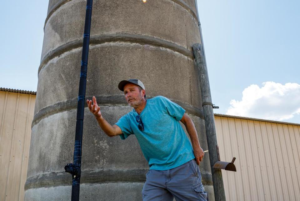 Ron Pilsner stands next to a cistern to store well water on his Nordheim, Texas property on Sept. 10, 2023. For the past few years, he's been testing the water quality from the underground well, which can be dirty or contaminated. Pilsner's land, which has been in his family for over a century, rests next to a recently-built drilling waste dump.