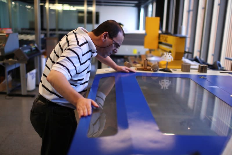 A technical staff works on the 3D printed protective visors made for healthcare professionals, amid the coronavirus disease (COVID-19) outbreak, at the Casa Firjan FabLab in Rio de Janeiro