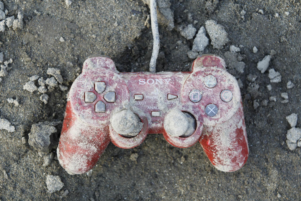 A Sony playstation controller is seen at an area that was devastated by last week's earthquake and tsunami, in Kesennuma, north Japan, March 19, 2011. REUTERS/Kim Kyung-Hoon (JAPAN - Tags: DISASTER SOCIETY) - GM1E73J1CCS01