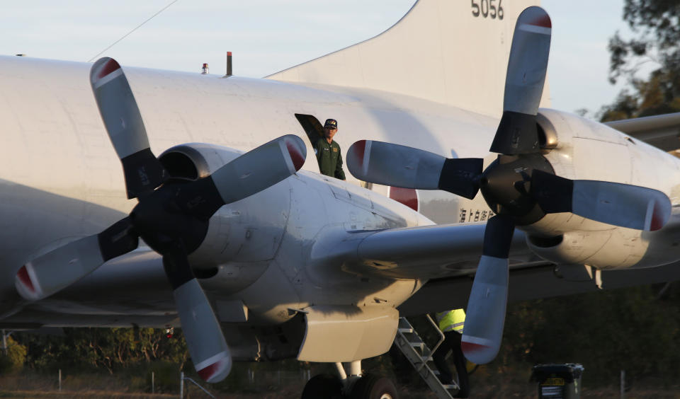 Japanese Commander Hidetsugu Iwamasa steps off his P3-C Orion of Japan Maritime Self-Defense Force after arriving to help with search operations for the missing Malaysia Airlines Flight MH370 at Royal Australian Air Force Pearce Base in Perth, Australia, Sunday, March 23, 2014. (AP Photo/Jason Reed, Pool)