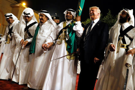 U.S. President Donald Trump dances with a sword as he arrives to a welcome ceremony by Saudi Arabia's King Salman bin Abdulaziz Al Saud at Al Murabba Palace in Riyadh, Saudi Arabia May 20, 2017. REUTERS/Jonathan Ernst