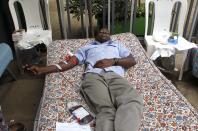 A man donates blood at a temporary donation centre for injured victims of a crossfire between armed men and the police at the Westgate shopping mall, in Kenya's capital Nairobi September 22, 2013. Islamist militants were holed up with hostages on Sunday at a shopping mall in Nairobi, where at least 59 people have been killed in an attack by the al Shabaab group that opposes Kenya's participation in a peacekeeping mission in neighboring Somalia. REUTERS/Thomas Mukoya (KENYA - Tags: CIVIL UNREST CRIME LAW)