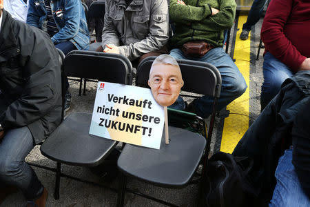 A mask depicting Heinrich Hiesinger, chief executive of ThyssenKrupp AG, during a Thyssenkrupp steel workers protest rally in Bochum, Germany, September 22, 2017, against the planned combination of the group's European steel operations with those of Tata Steel. Placard reads "Don't sell our future". REUTERS/Wolfgang Rattay