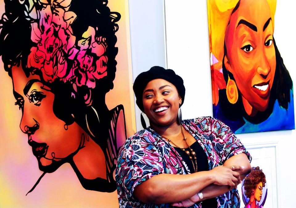 Artist Jasmine Wyatt poses next to some of her artwork at the Bronzeville Collective, 393 West North Ave.