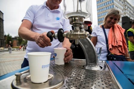 Adam Grabowski serves fizzy water to locals in Katowice