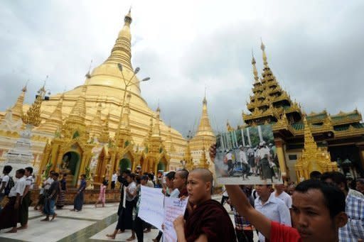 Rakhine Buddhist monks and demonstrators hold banners and pictures as they gather at Yangon's Shwedagon pagoda after unrest flared in the western Myanmar state on June 10. Dozens of people have been killed in a surge in sectarian violence in Myanmar, an official says as international pressure mounts for an end to the bloodshed